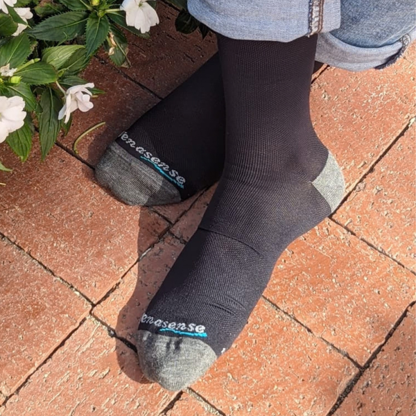 Black knee-high compression socks worn with jeans, an easy everyday look for desk days