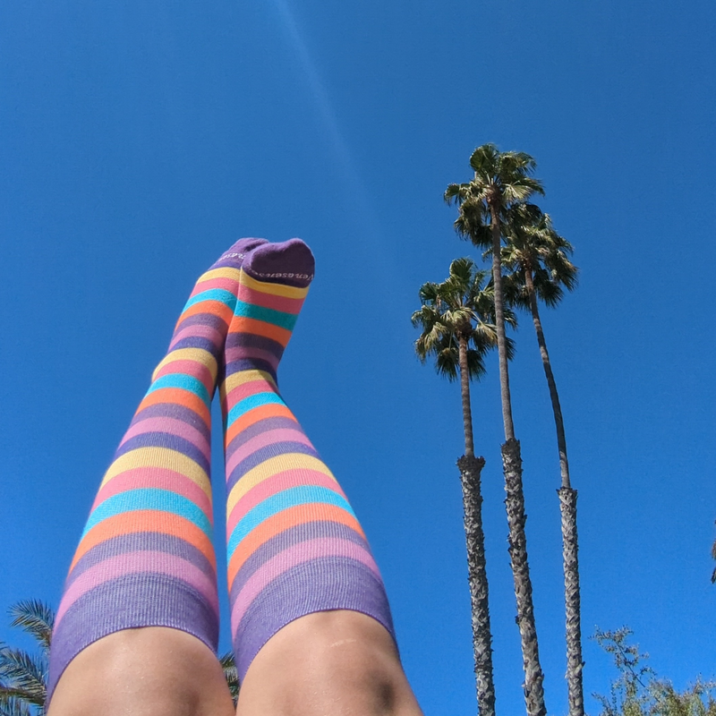 Detail of rainbow striped knee-high compression socks designed in California