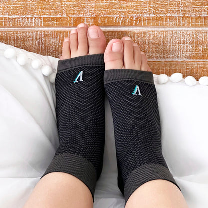 Plantar Fasciitis Socks in woman feet while in bed