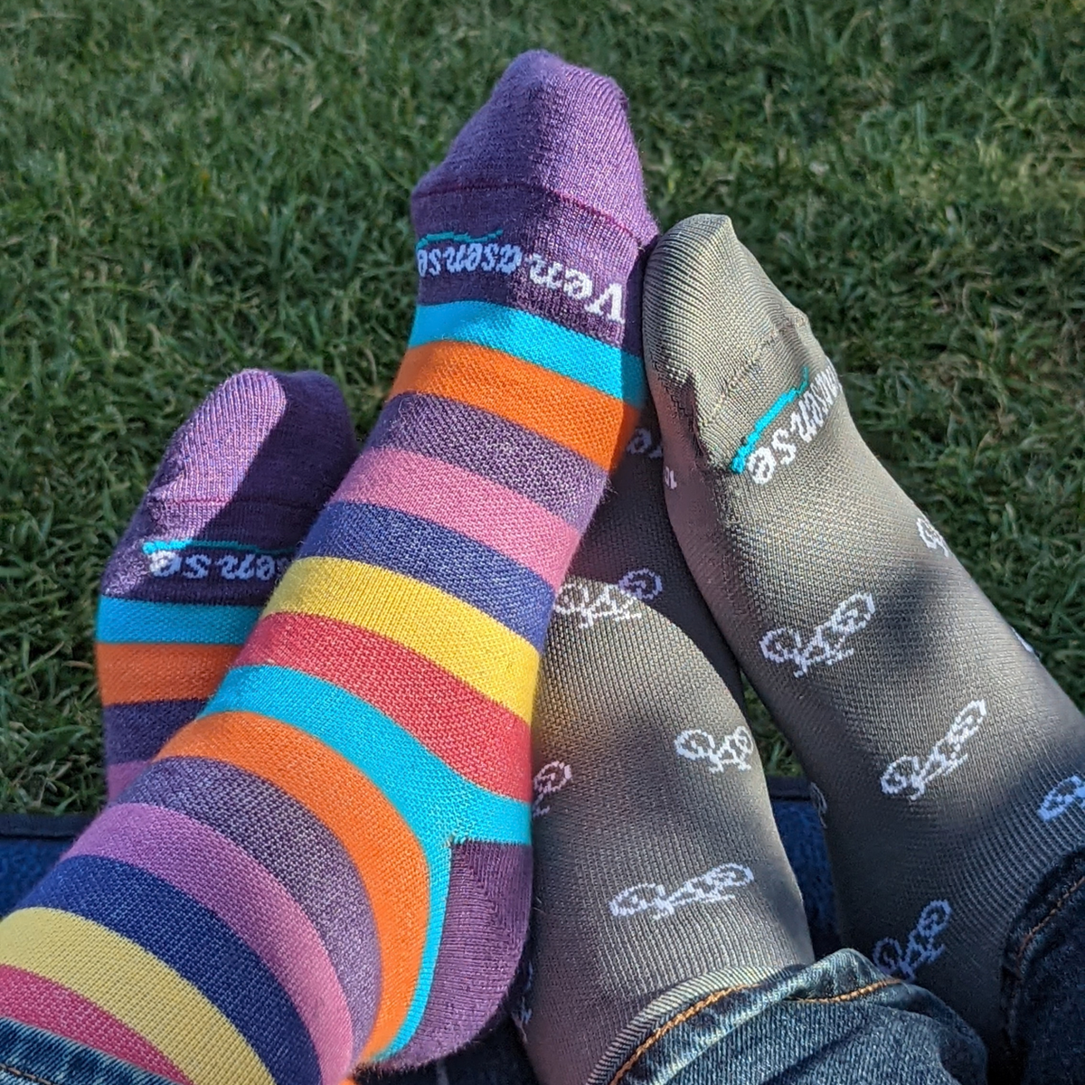 Knee-High Compression Socks in Rainbow Pink and Gray Bicycles – two pairs worn outdoors on grass, lifestyle photo