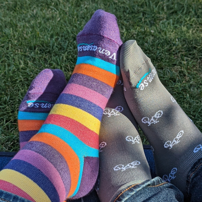 Knee-High Compression Socks in Rainbow Pink and Gray Bicycles – two pairs worn outdoors on grass, lifestyle photo