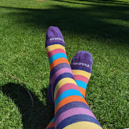 Knee-High Compression Socks in Rainbow Pink – worn outdoors on grass, lifestyle photo